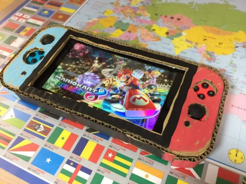 Son papa glisse alors une vraie Nintendo Switch sous le carton